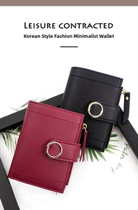 Detail of lychee pattern leather wallet with golden ring buckle and zipper closure