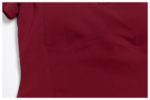 Detailed close-up of wine red athletic set showing professional curved flat-lock stitching