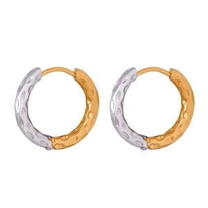 Minimalist gold and silver two-tone hoop earrings with a textured hammered finish