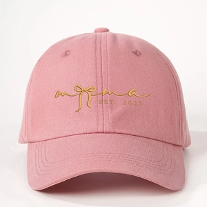 Pink baseball cap with gold Mama Est. 2025 embroidery and bow detail on cotton twill