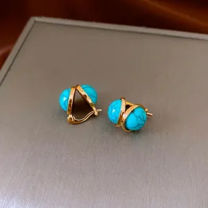 Vintage golden U-shaped earrings with turquoise beads and unique black vein textures