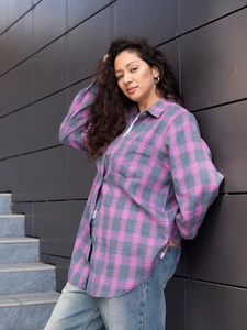 Detail of pink and gray plaid flannel shirt with drop shoulder and casual loose fit