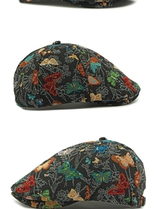 Detail of vintage ethnic beret featuring colorful butterfly jacquard and stiff short brim