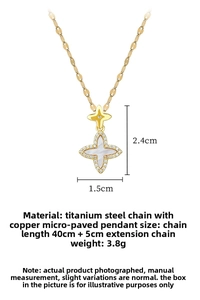 Macro view of gold clover star necklace with shell inlay and cubic zirconia details