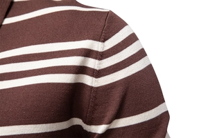 Macro detail of the shoulder seam and texture of the brown and white striped knit polo