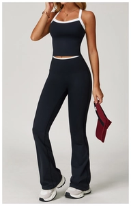 Detail of high-waisted yoga flared pants with white contrast piping and split hem design