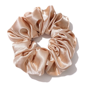 Elegant champagne satin oversized scrunchie with smooth silk texture and metallic luster
