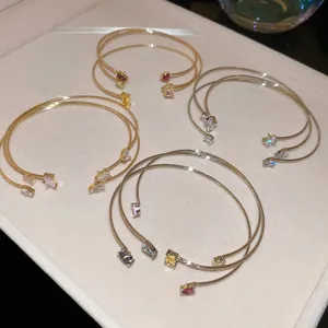 Three-piece set of elegant open bangles featuring colorful zircon stones in gold and silver