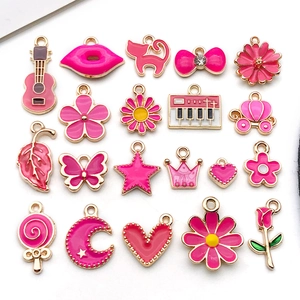 Flat lay of 20 pink enamel alloy charms for DIY bracelets and earrings on white background