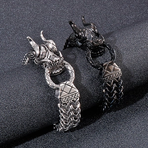 Close-up of dragon head bracelets in silver and black stainless steel with woven chain