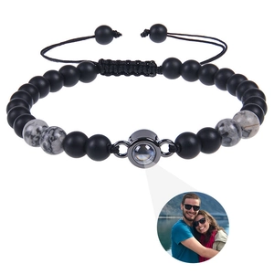 Detail of matte stone photo projection bracelet showing custom couple image beam