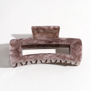 Detailed close-up of a square hair claw clip with taupe marble pattern on white background