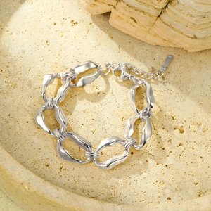Detailed macro shot of silver chunky chain bracelet with asymmetric twisted organic links