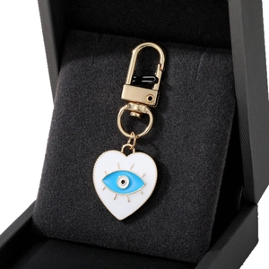 Golden heart-shaped devil eye keychain pendant presented in a luxury black gift box