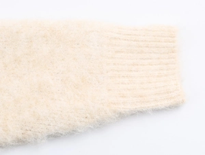 Macro shot of off-white mohair knit sweater cuff with ribbed knit edge detail