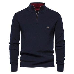 Detail of navy knit sweater with half-zip stand collar and red inner contrast lining