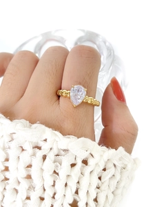 Pear cut zircon ring with 18K gold beaded texture band shown on finger