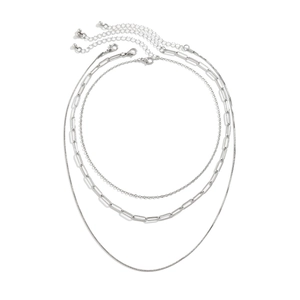 Detailed close-up of layered silver snake chain and paperclip link necklaces on white background