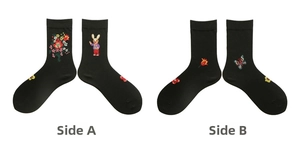 Detail of black cotton socks featuring colorful floral and rabbit embroidery side A and B