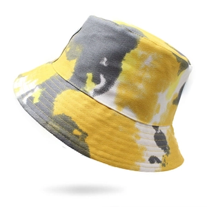 Detailed view of tie-dye bucket hat featuring yellow and black print and reinforced stitching
