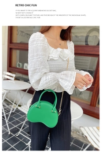Detail of green PVC jelly handbag with golden chain strap and cloud-shaped design