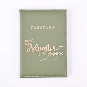 Close-up of sage green PU leather passport cover with rose gold adventure engraving
