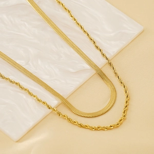 Detail of 18k gold plated stainless steel herringbone and rope chain necklace set