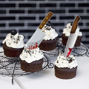 Set of two bloody horror knife cake toppers for Halloween party decoration on a black wall