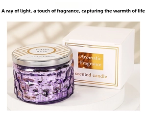 Detail of purple embossed glass scented candle with silver lid and velvet rose gift box