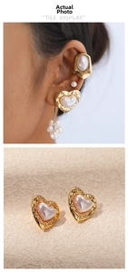 Detail of vintage heart pearl earrings and gold ear cuffs set worn by a model