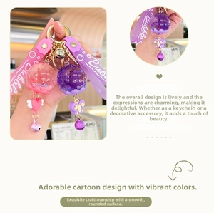 Detail of creative liquid oil wind chime keychain with star glitter and gold bell charm