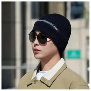 Detailed knit texture of dark blue ribbed winter hat with grey stripe and Narason label