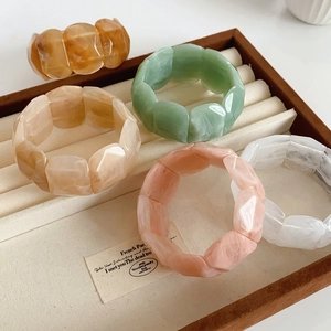 Macro shot of geometric acrylic bangles with marble textures in various colors