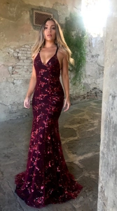 Detail of burgundy sequin evening dress featuring deep V-neck and mermaid silhouette
