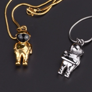 Detailed view of astronaut pendants in gold and silver finish with sleek snake chains