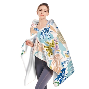 Detail of soft microfiber beach towel with vibrant colorful marine life patterns