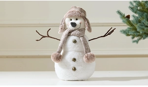 Detail of Christmas snowman plush with white faux fur, knitted scarf, and wood-like arms