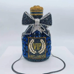 Detailed view of dark blue crystal clutch with sparkling bow and golden VIP lettering