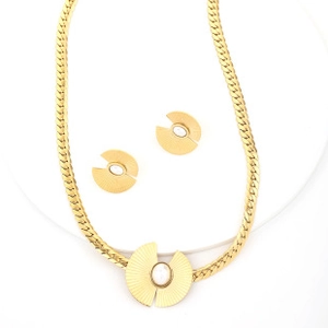 Detail of gold Cuban chain necklace and matching fan-shaped opal stud earrings set