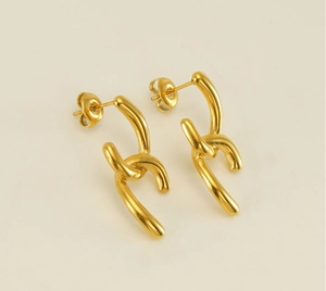 Detail view of irregular 18k gold plated stainless steel stud earrings with curved design