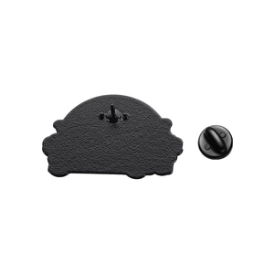 Close-up of black enamel pin back with textured metal finish and matching rubber clutch