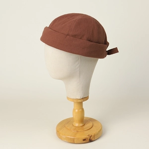 Street style dark brown cotton docker cap with rolled cuff on mannequin head