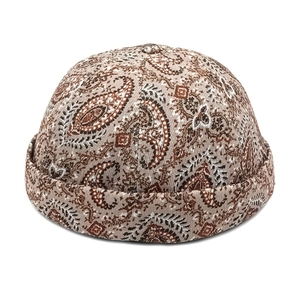 Close-up of vintage paisley pattern on a brown miki hat with woven texture