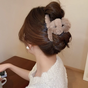 Close-up of brown plush faux fur hair claw clip showing soft texture and rabbit ear design