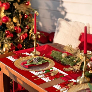 Christmas placemat set with red poinsettia floral design on festive wooden table setting