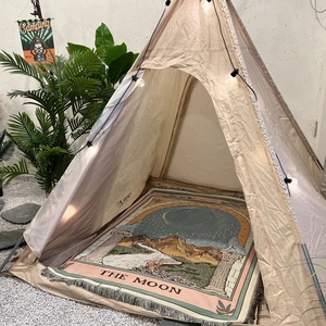 Detailed view of bohemian tarot woven blanket used as a camping mat in outdoor setup