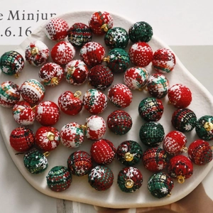 DIY Christmas fabric balls with houndstooth patterns and gold rings in a ceramic tray