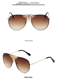 Detail view of gold aviator sunglasses with gradient tea lenses and a small bee decor