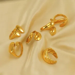 Minimalist 18k gold plated stainless steel open rings set on champagne satin fabric