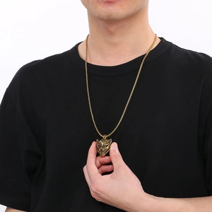 Close-up of hip hop gold leopard head pendant on a black shirt for men